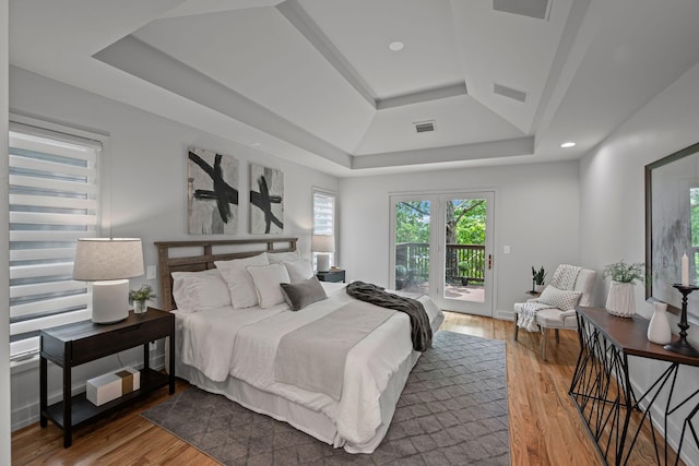 635 Harpeth Trace Dr, Nashville, TN 37221 - bedroom featuring visible vents, a raised ceiling, wood finished floors, and access to exterior
