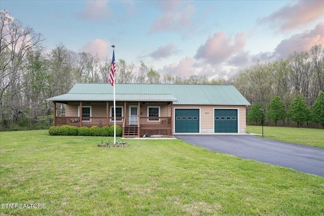 547 Clear Creek Ln, Monterey, TN 38574 - ranch-style house featuring driveway, metal roof, covered porch, a garage, and a front yard