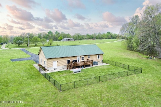 547 Clear Creek Ln, Monterey, TN 38574 - back of house with a fenced backyard, a deck, metal roof, and a lawn