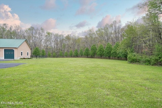 547 Clear Creek Ln, Monterey, TN 38574 - view of yard featuring fence, driveway, a wooded view, and a garage