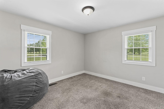 unfurnished bedroom featuring baseboards, visible vents, and carpet