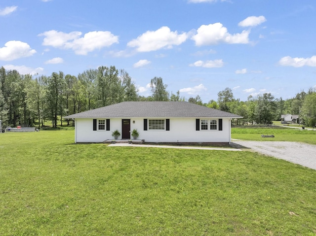 ranch-style home featuring driveway and a front yard