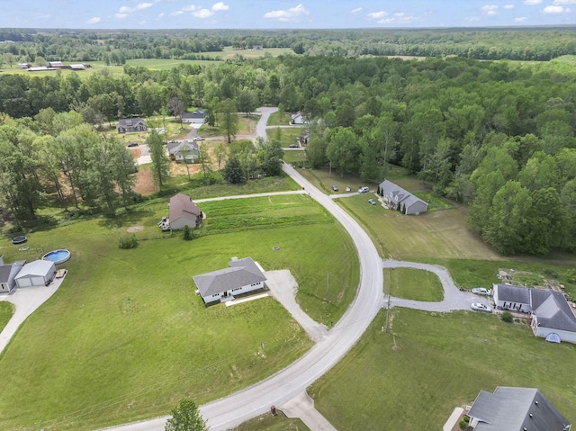 drone / aerial view featuring a forest view