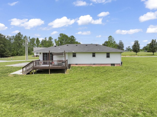 back of property featuring a yard, crawl space, a wooden deck, and roof with shingles