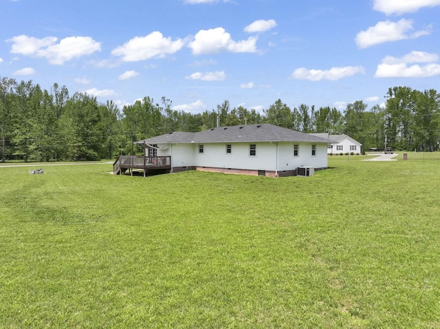 back of property featuring a lawn, central AC unit, a deck, and crawl space