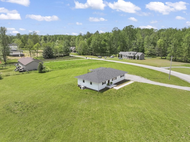 bird's eye view featuring a wooded view