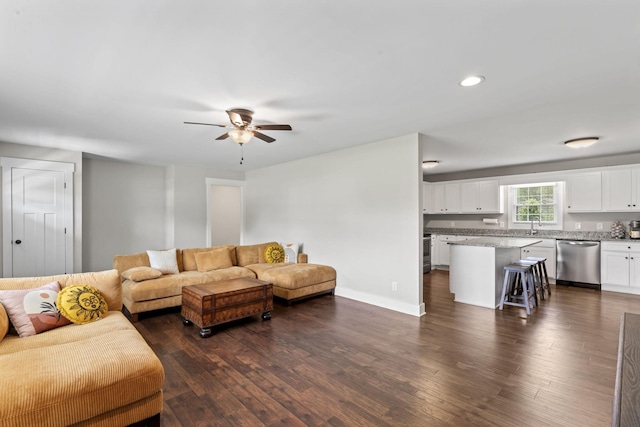 living area with recessed lighting, baseboards, ceiling fan, and dark wood-style flooring