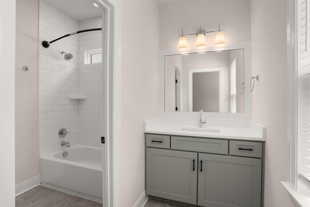 full bathroom with shower / bathing tub combination, vanity, and baseboards