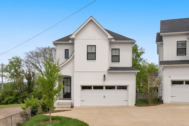 view of front of property featuring a garage, board and batten siding, and concrete driveway