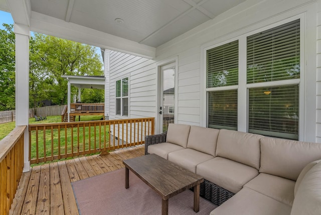 wooden terrace with fence, outdoor lounge area, and a yard
