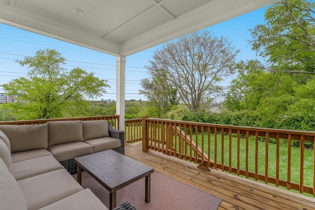 wooden deck with an outdoor living space and a yard