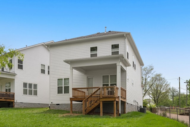 rear view of house featuring a lawn, crawl space, a wooden deck, and cooling unit