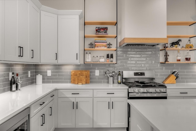 kitchen featuring open shelves, stainless steel appliances, white cabinets, and backsplash