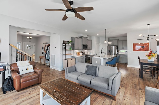 7025 Bennett Dr, Mount Juliet, TN 37122 - living area featuring ceiling fan with notable chandelier, light wood finished floors, baseboards, visible vents, and recessed lighting