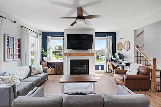 7025 Bennett Dr, Mount Juliet, TN 37122 - living area with ceiling fan, a healthy amount of sunlight, a glass covered fireplace, and stairs