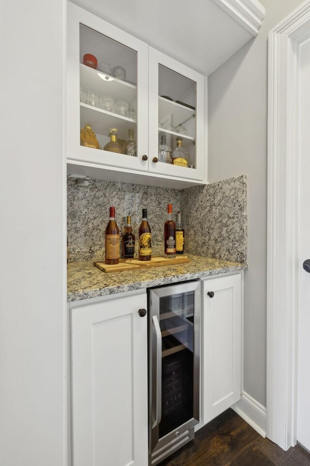 124 Houghland St, Gallatin, TN 37066 - bar featuring wine cooler, dark wood-style floors, baseboards, a bar, and decorative backsplash