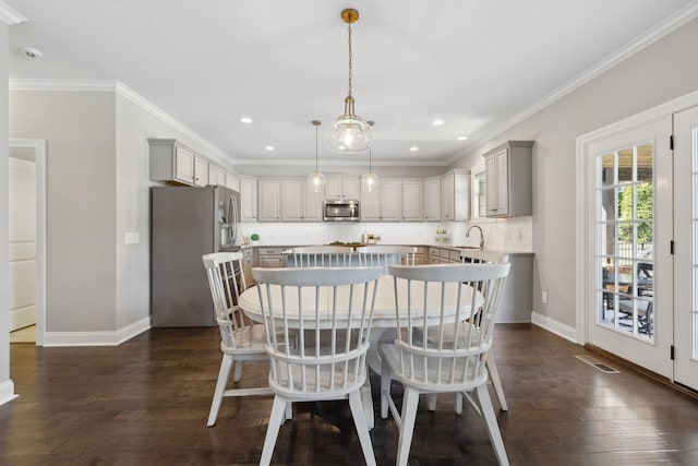 124 Houghland St, Gallatin, TN 37066 - dining room featuring dark wood-style flooring, visible vents, baseboards, and ornamental molding