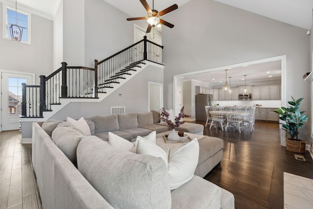 124 Houghland St, Gallatin, TN 37066 - living area featuring high vaulted ceiling, dark wood finished floors, a ceiling fan, and stairway