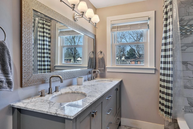 474 Sunliner Dr, Nashville, TN 37209 - bathroom with a sink, baseboards, double vanity, and a shower with shower curtain