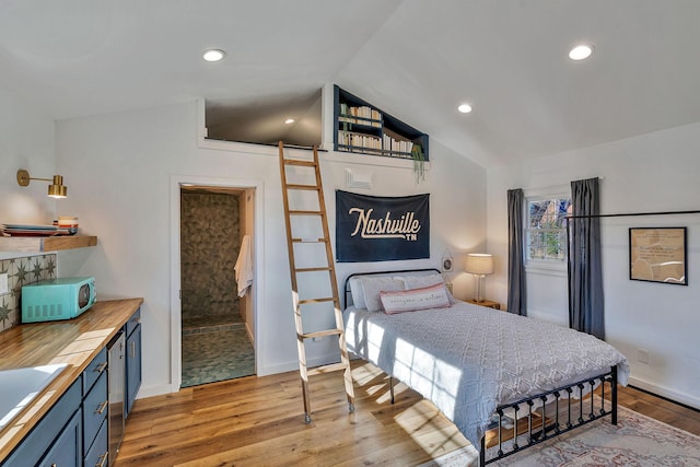 474 Sunliner Dr, Nashville, TN 37209 - bedroom with a barn door, light wood-style floors, recessed lighting, baseboards, and lofted ceiling