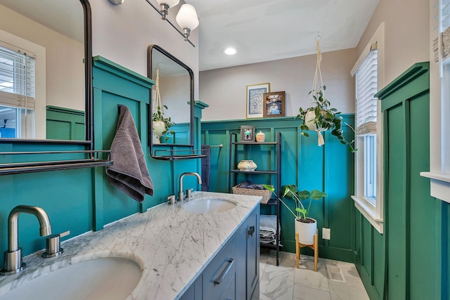 474 Sunliner Dr, Nashville, TN 37209 - bathroom featuring a sink, wainscoting, and a decorative wall