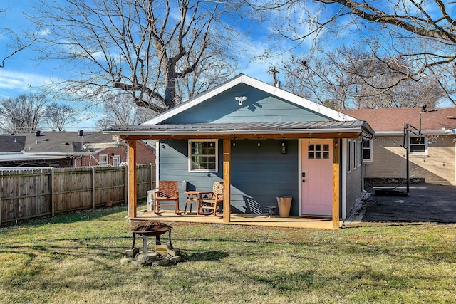 474 Sunliner Dr, Nashville, TN 37209 - rear view of house with fence, a lawn, and metal roof