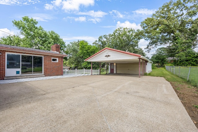 208 Orleans Dr, Clarksville, TN 37042 - garage featuring a carport and driveway
