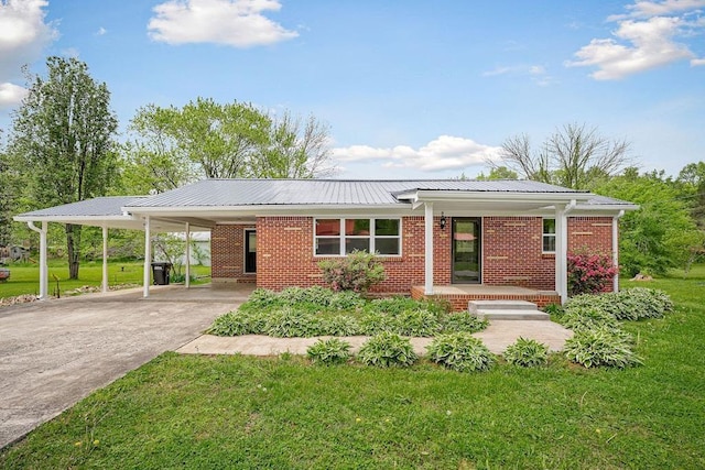 ranch-style house with a carport, a front lawn, brick siding, and concrete driveway