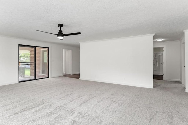 unfurnished living room featuring baseboards, a ceiling fan, a textured ceiling, and carpet