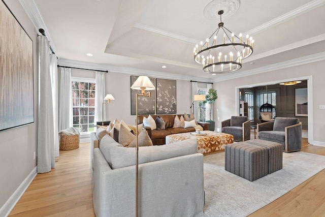 2931 Longford Dr, Murfreesboro, TN 37129 - living area featuring an inviting chandelier, a tray ceiling, ornamental molding, light wood-type flooring, and baseboards