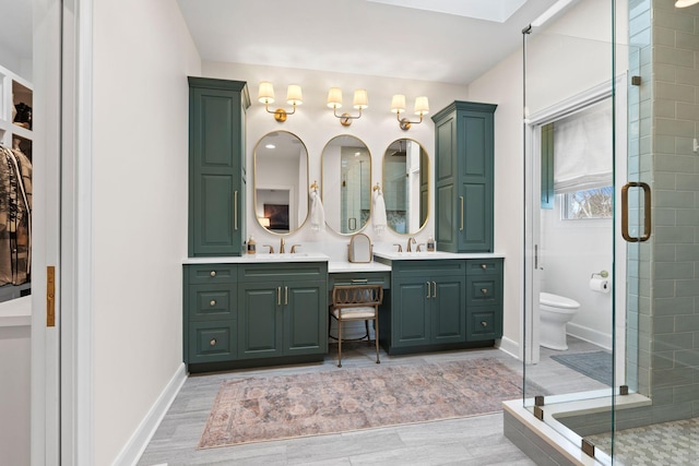 2931 Longford Dr, Murfreesboro, TN 37129 - bathroom with wood finished floors, a sink, a shower stall, and double vanity