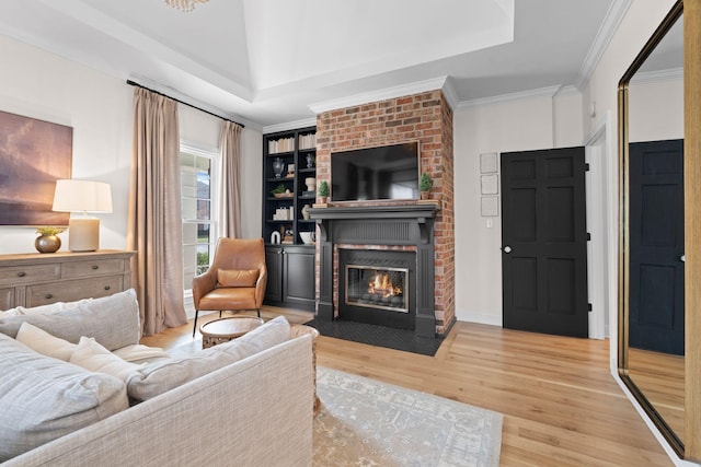 2931 Longford Dr, Murfreesboro, TN 37129 - living area featuring a fireplace, a raised ceiling, wood finished floors, and ornamental molding