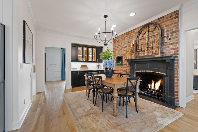 2931 Longford Dr, Murfreesboro, TN 37129 - dining space featuring a fireplace, recessed lighting, light wood-style floors, and crown molding
