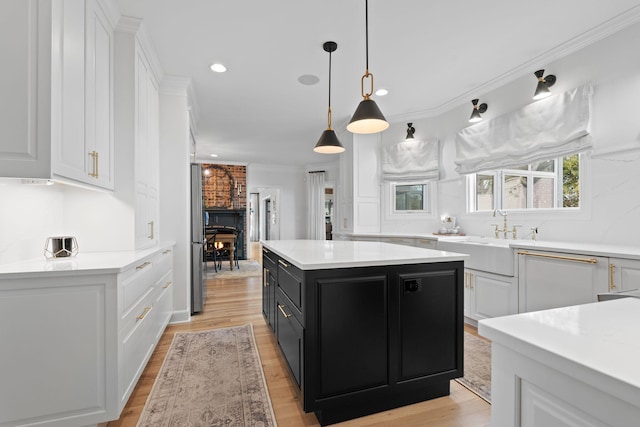2931 Longford Dr, Murfreesboro, TN 37129 - kitchen with white cabinets, light countertops, dark cabinetry, a sink, and crown molding