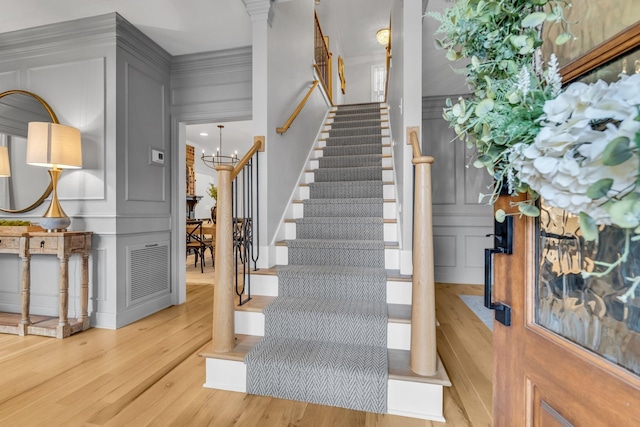 2931 Longford Dr, Murfreesboro, TN 37129 - staircase featuring a decorative wall, a chandelier, wood finished floors, and visible vents