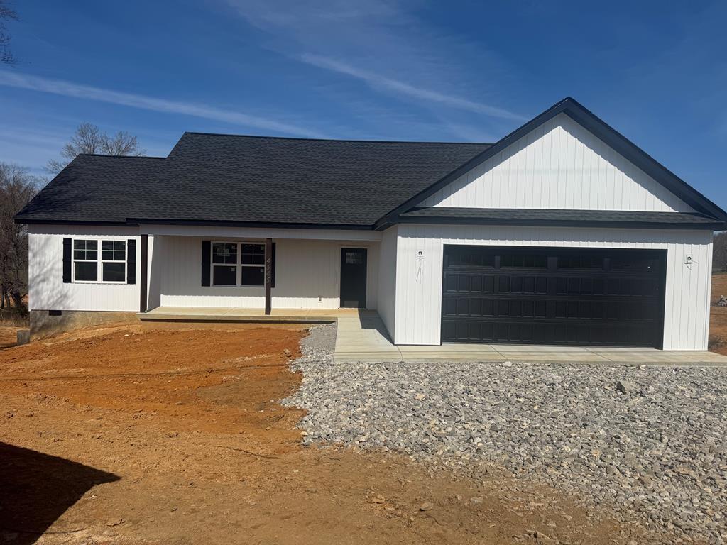 4545 Window Cliff Rd, Baxter, TN 38544 - view of front of home with an attached garage, driveway, a porch, and roof with shingles