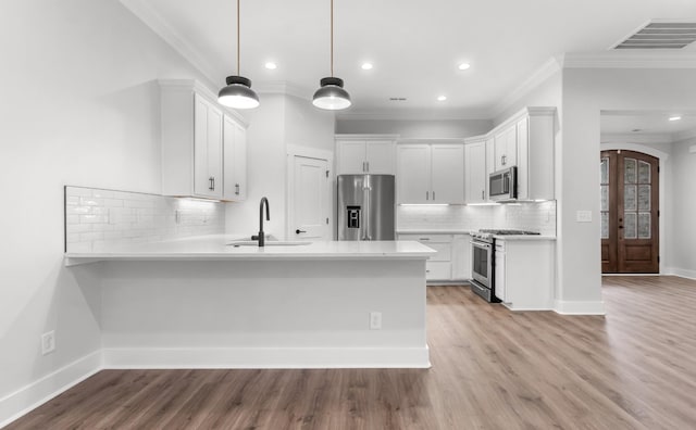 1048 Veridian Dr B, Clarksville, TN 37043 - kitchen with crown molding, a sink, high end appliances, a peninsula, and visible vents