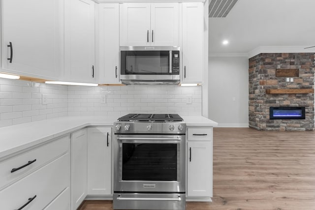1048 Veridian Dr B, Clarksville, TN 37043 - kitchen featuring ornamental molding, appliances with stainless steel finishes, white cabinets, and light countertops