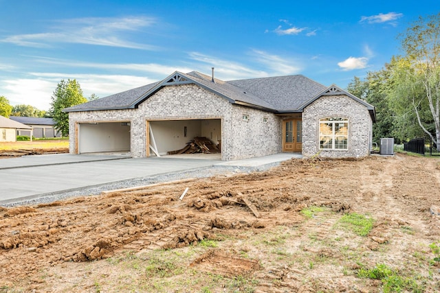 1048 Veridian Dr B, Clarksville, TN 37043 - view of front facade featuring a garage, driveway, brick siding, and roof with shingles