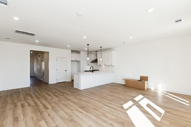 unfurnished living room featuring light wood-type flooring, visible vents, and recessed lighting