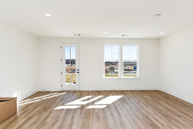 unfurnished room with baseboards, visible vents, recessed lighting, and light wood-style floors