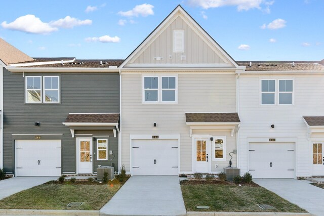 view of front of home with central air condition unit, driveway, and board and batten siding