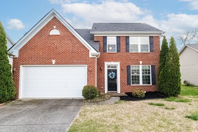 view of front of house with concrete driveway, a front lawn, brick siding, and a garage