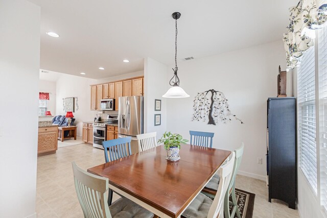 dining area featuring light tile patterned floors, a healthy amount of sunlight, visible vents, and recessed lighting