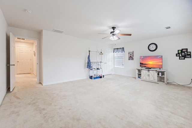 unfurnished living room featuring carpet floors, visible vents, a ceiling fan, and baseboards