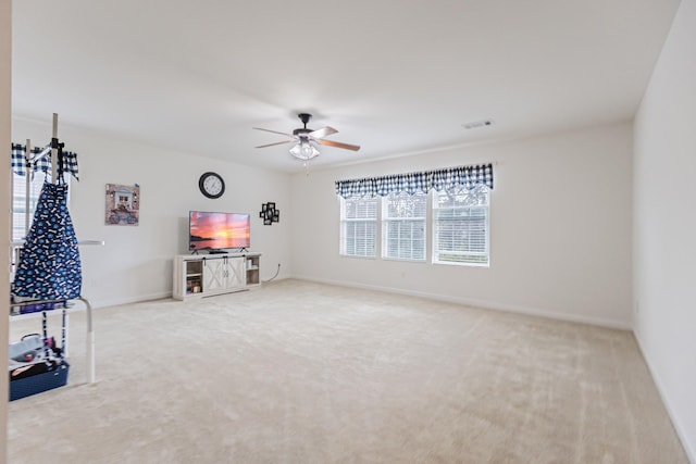 interior space with ceiling fan, baseboards, and carpet flooring