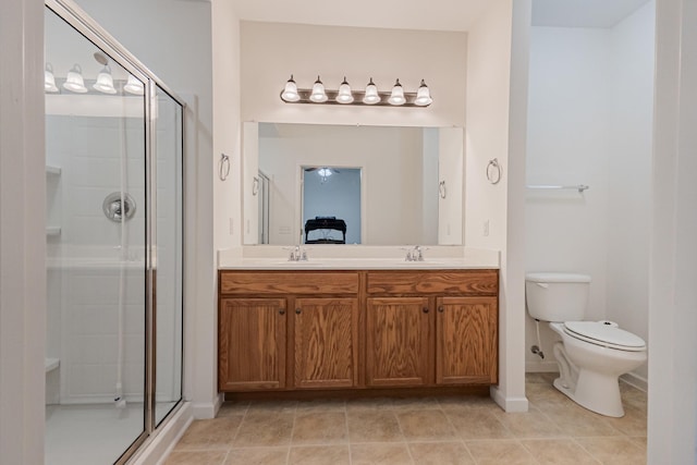 full bath featuring toilet, a sink, double vanity, and a stall shower