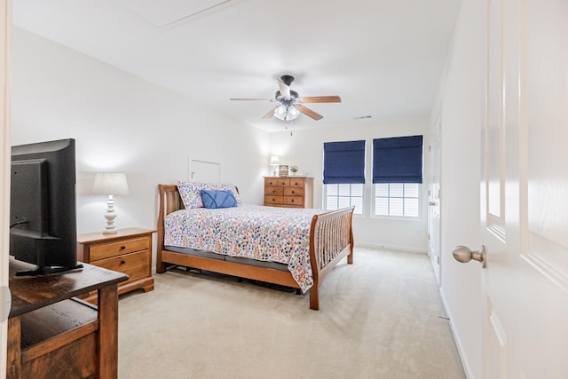 bedroom featuring light colored carpet, ceiling fan, baseboards, and visible vents