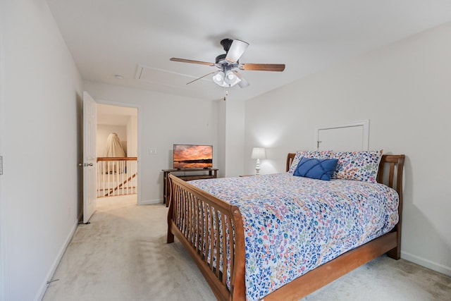 carpeted bedroom with attic access, a ceiling fan, and baseboards