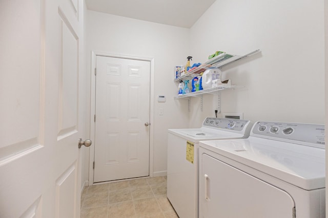 washroom with washing machine and clothes dryer and laundry area